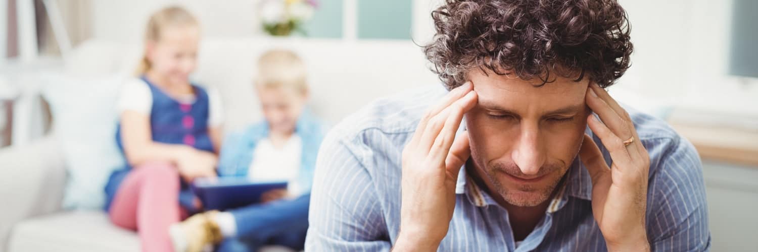 A stressed father with two children